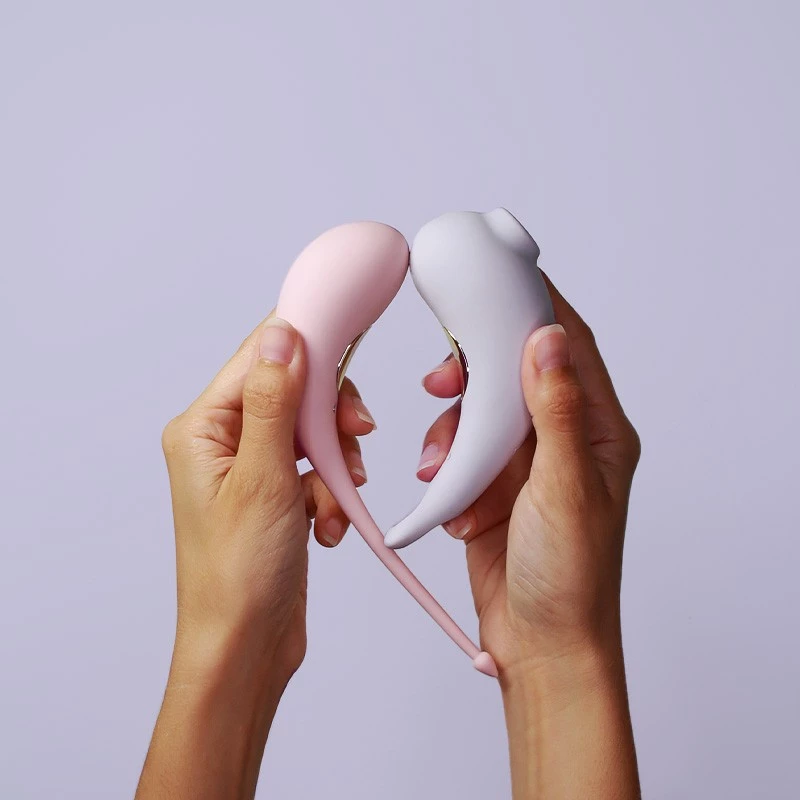 Maloo Maga - Aspirateur clitoris Lilas à droite & Oeuf vibrant connecté rose pastel a gauche tenus dans les mains Maloo Maga - Aspirateur clitoris Lilas à droite & Oeuf vibrant connecté rose pastel a gauche tenus dans les mains